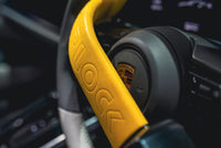 Yellow Stoplock Pro Elite steering wheel lock close up showing hardened steel construction and twin locking forks