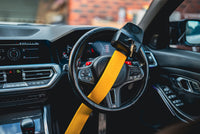 Stoplock Pro Elite installed on a luxury car interior steering wheel as a visible theft deterrent